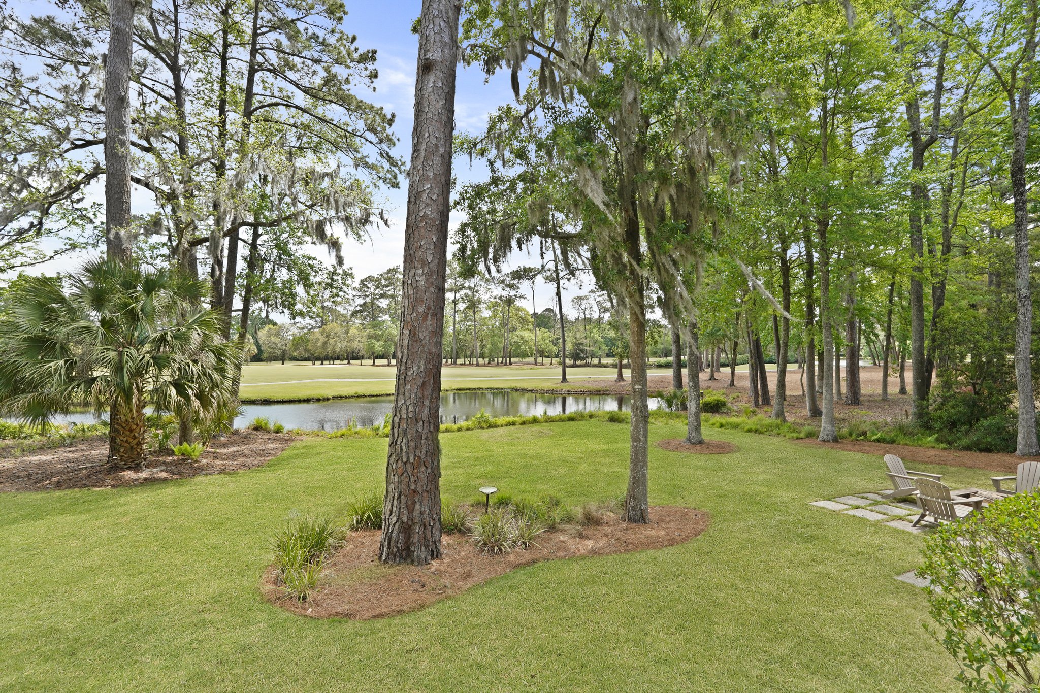 Elegant Moss Creek home with lagoon-to-golf views, screened porch, and Lowcountry charm at 128 Timber Lane